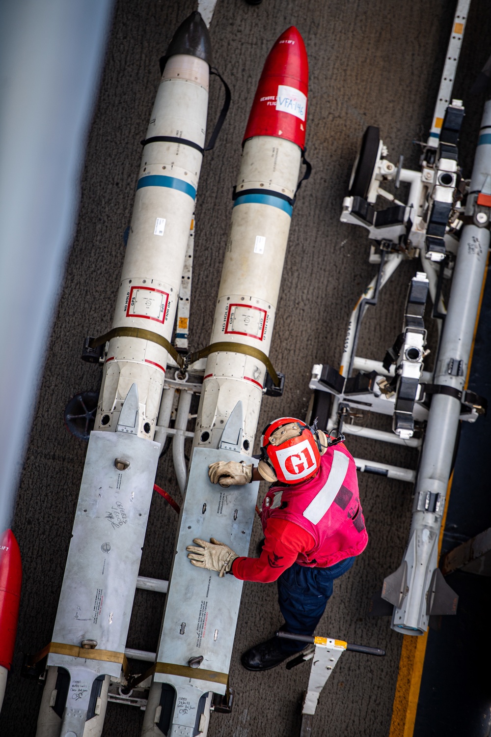 Sailor Prepares To Move Ordnance