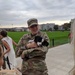 A US Military Academy Cadet cradles a therapy dog during a support event on West Point