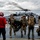 U.S. Navy Sailors Unload Gear From A Helicopter