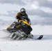 U.S. Navy Explosive Ordnance Disposal Technician Drives a Snowmobile