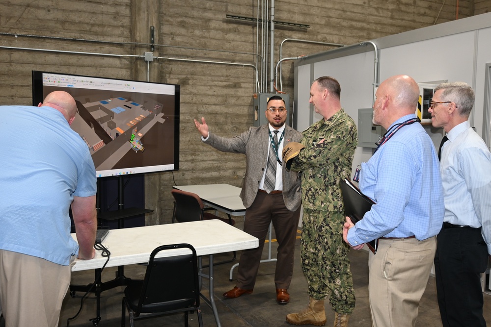 Steven Burrill, NBC 5G smart warehouse logistics program lead, NAVSUP FLC San Diego, provides a warehouse technology presentation to Capt. David Carnal, commanding officer, NAVSUP BSC during a visit to the area, Feb 6.