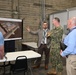 Steven Burrill, NBC 5G smart warehouse logistics program lead, NAVSUP FLC San Diego, provides a warehouse technology presentation to Capt. David Carnal, commanding officer, NAVSUP BSC during a visit to the area, Feb 6.