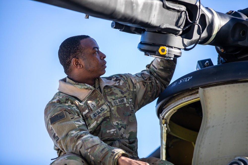 U.S. Army Soldier Performs Post-Flight Maintenance