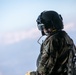 U.S. Army Soldier scans the horizon while on the back of a CH-47 Chinook