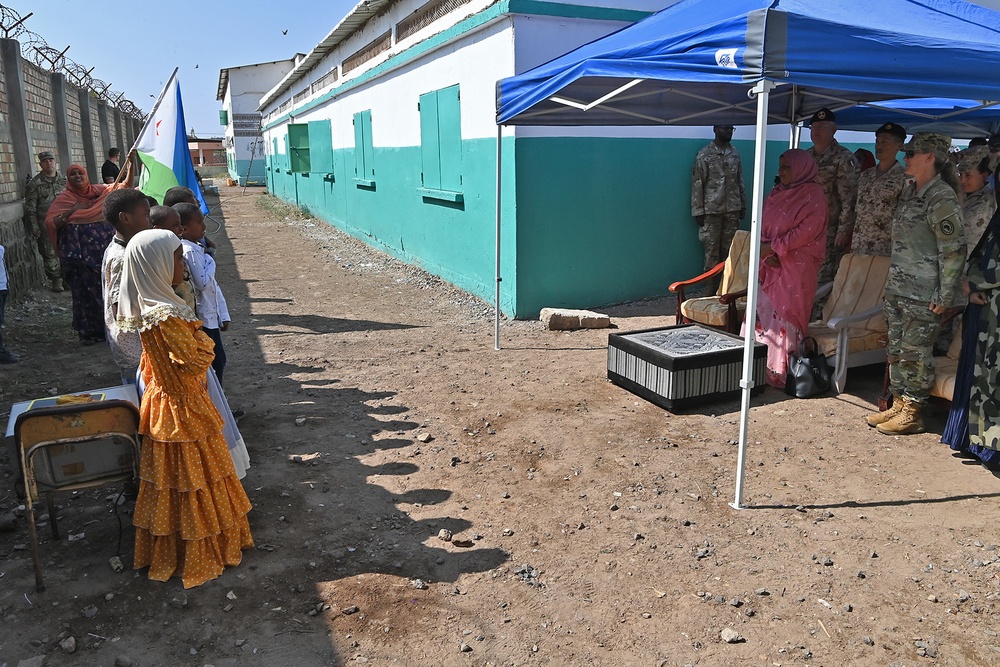Commanding General of Combined Joint Task Force – Horn of Africa reads to children at the Balbala 3 School