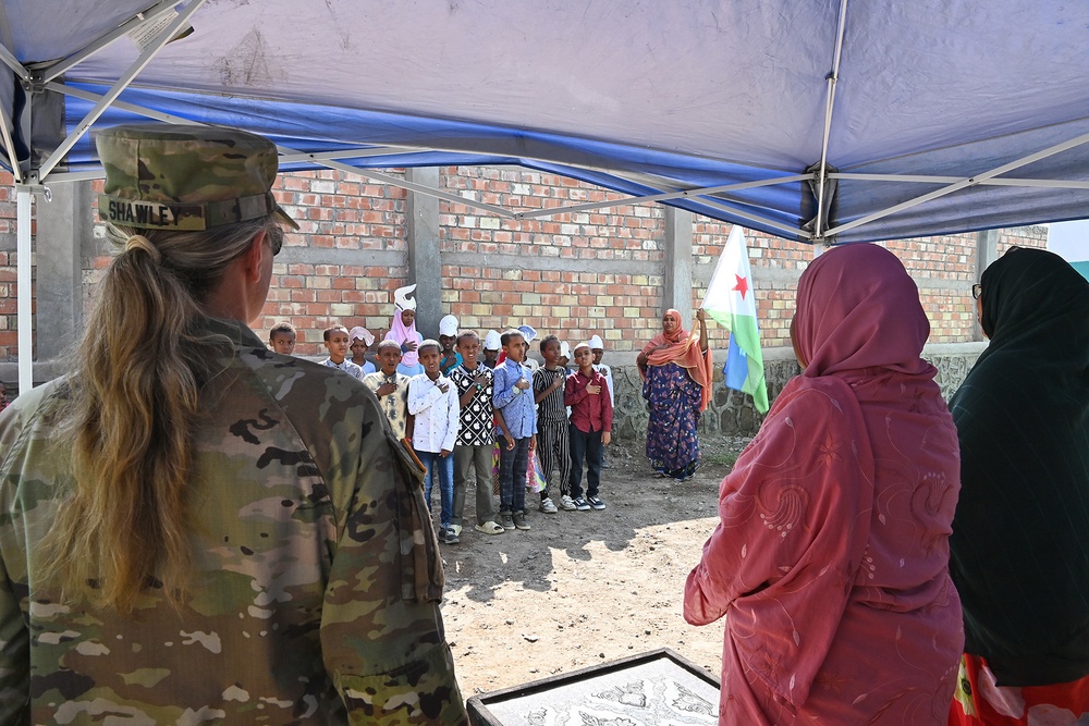 Commanding General of Combined Joint Task Force – Horn of Africa reads to children at the Balbala 3 School