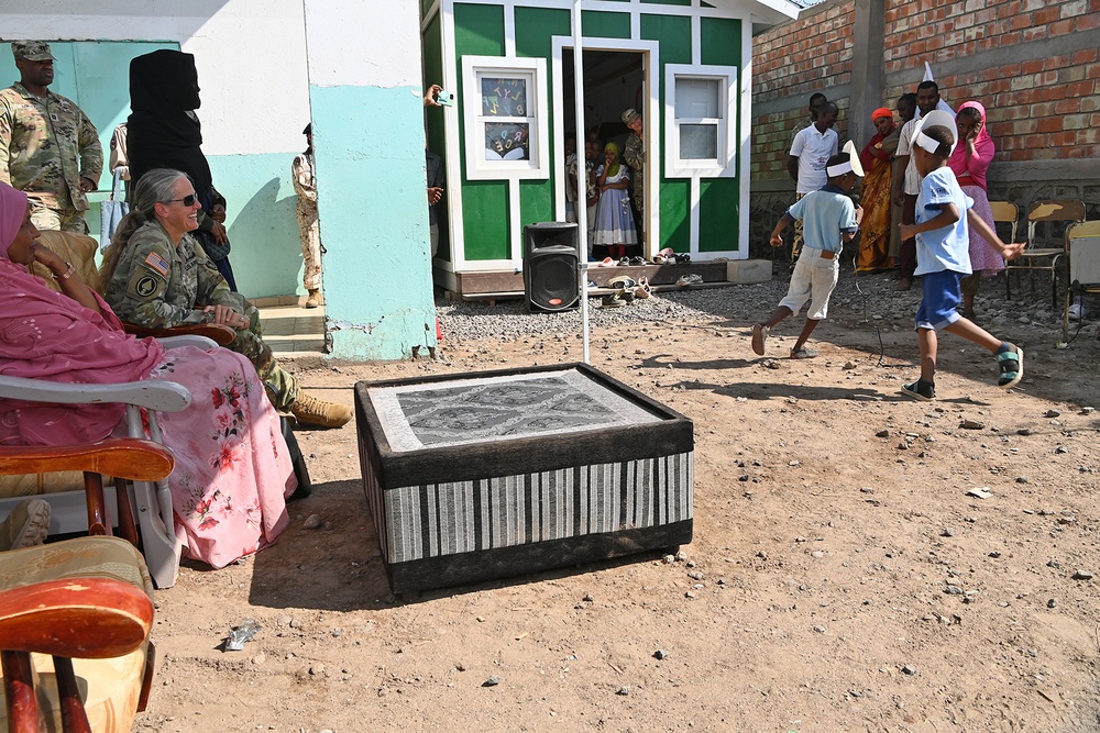 Commanding General of Combined Joint Task Force – Horn of Africa reads to children at the Balbala 3 School