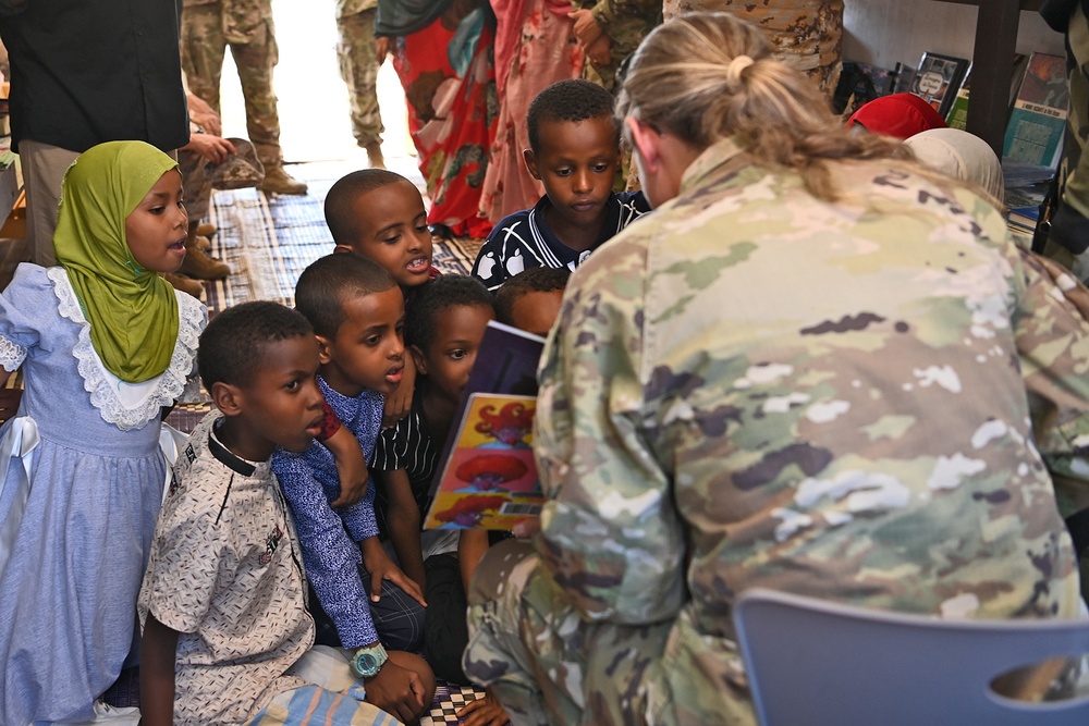 Commanding General of Combined Joint Task Force – Horn of Africa reads to children at the Balbala 3 School