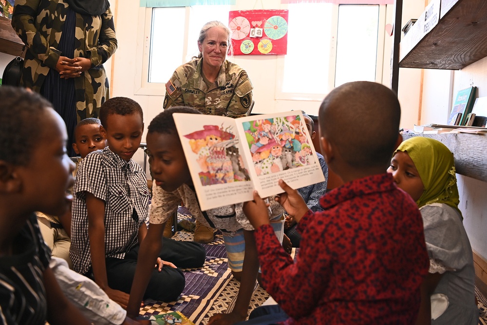 Commanding General of Combined Joint Task Force – Horn of Africa reads to children at the Balbala 3 School
