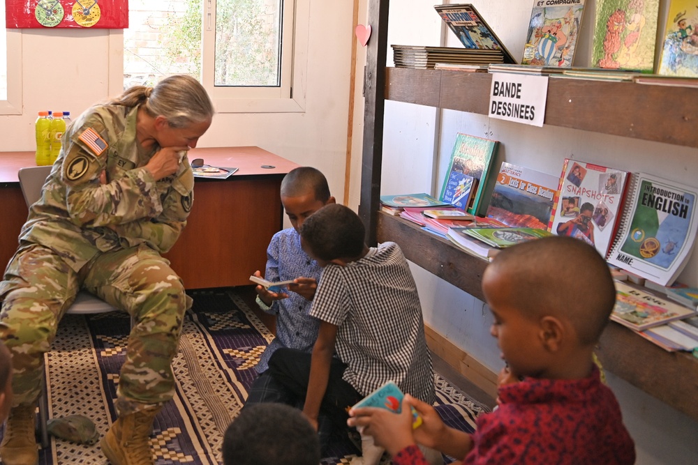 Commanding General of Combined Joint Task Force – Horn of Africa reads to children at the Balbala 3 School
