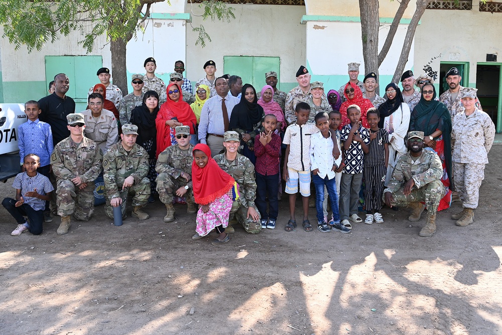 Commanding General of Combined Joint Task Force – Horn of Africa reads to children at the Balbala 3 School