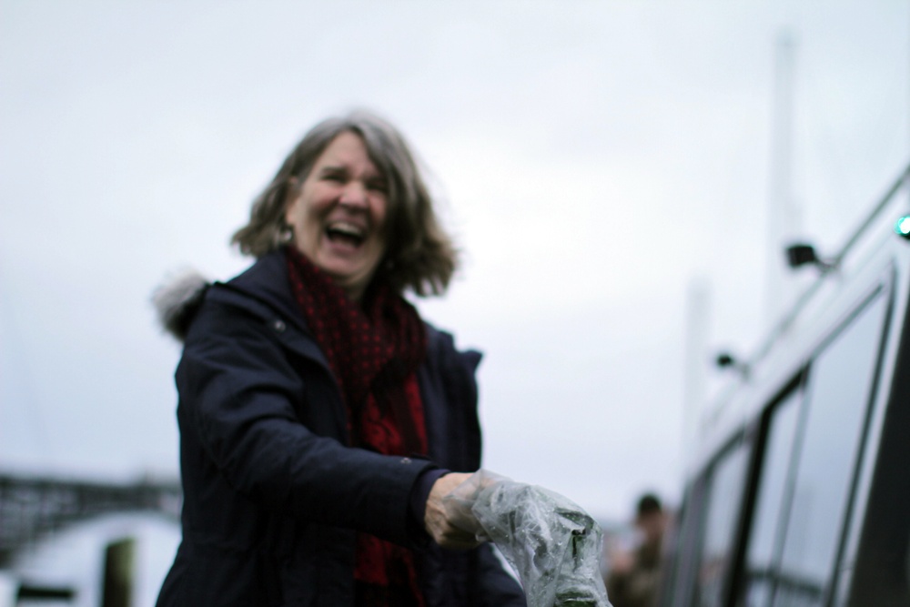 Beeman family member breaks champagne bottle christening USACE survey vessel Beeman