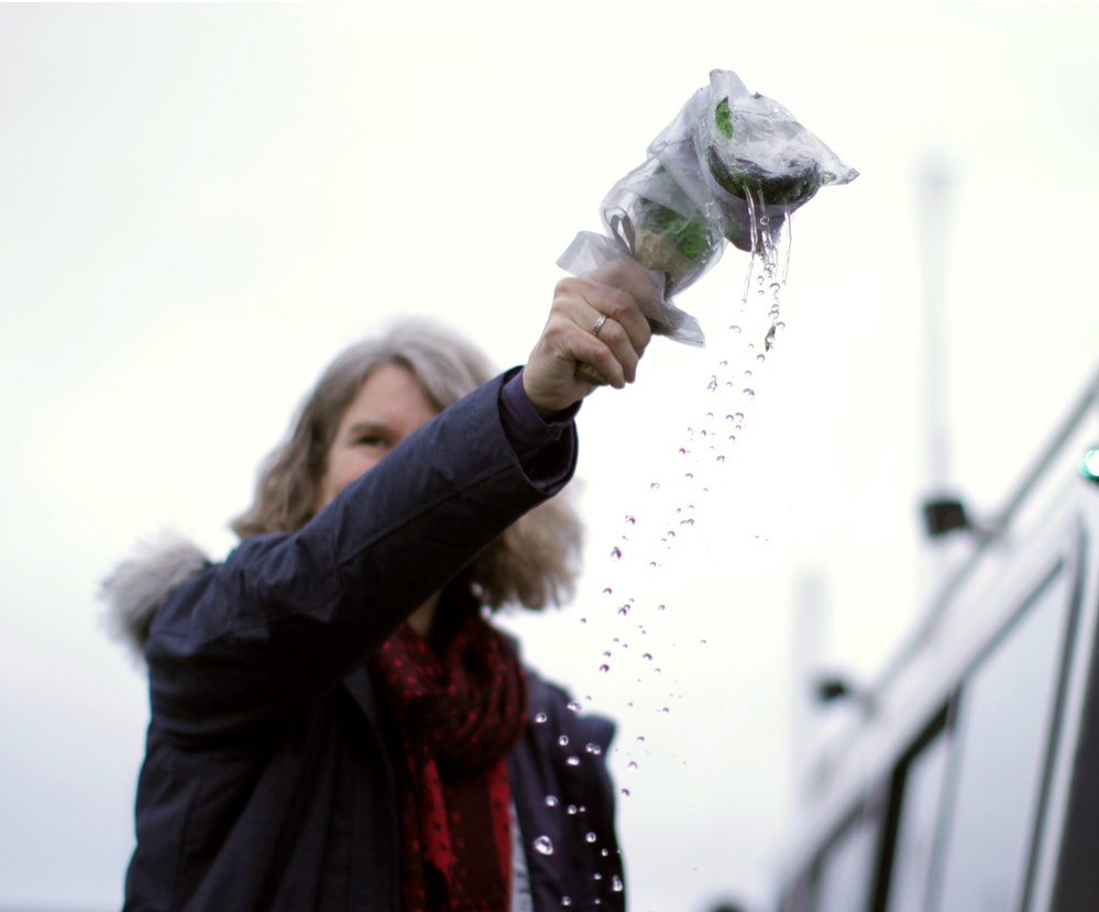 Beeman family member breaks champagne bottle christening USACE survey vessel Beeman