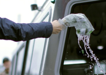 Beeman family member breaks champagne bottle christening USACE survey vessel Beeman