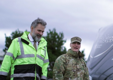Beeman family member walks with Army chaplain on their way to christen USACE survey vessel Beeman.