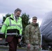 Beeman family member walks with Army chaplain on their way to christen USACE survey vessel Beeman.