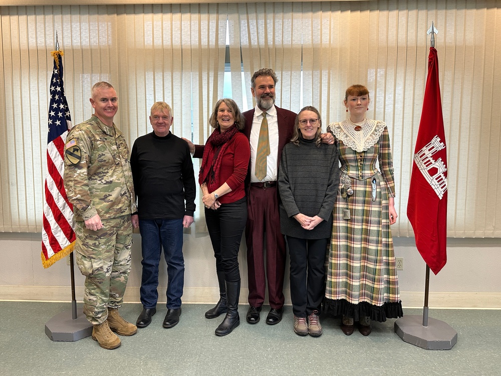 The Beeman family pose for a picture with district commander Col. Helton at the christening ceremony for survey vessel Beeman.