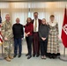 The Beeman family pose for a picture with district commander Col. Helton at the christening ceremony for survey vessel Beeman.