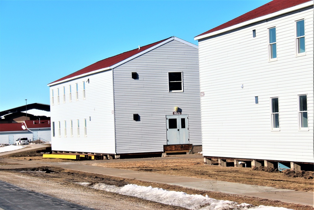 Contractors moving four World War II-era barracks buildings at Fort McCoy