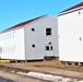 Contractors moving four World War II-era barracks buildings at Fort McCoy