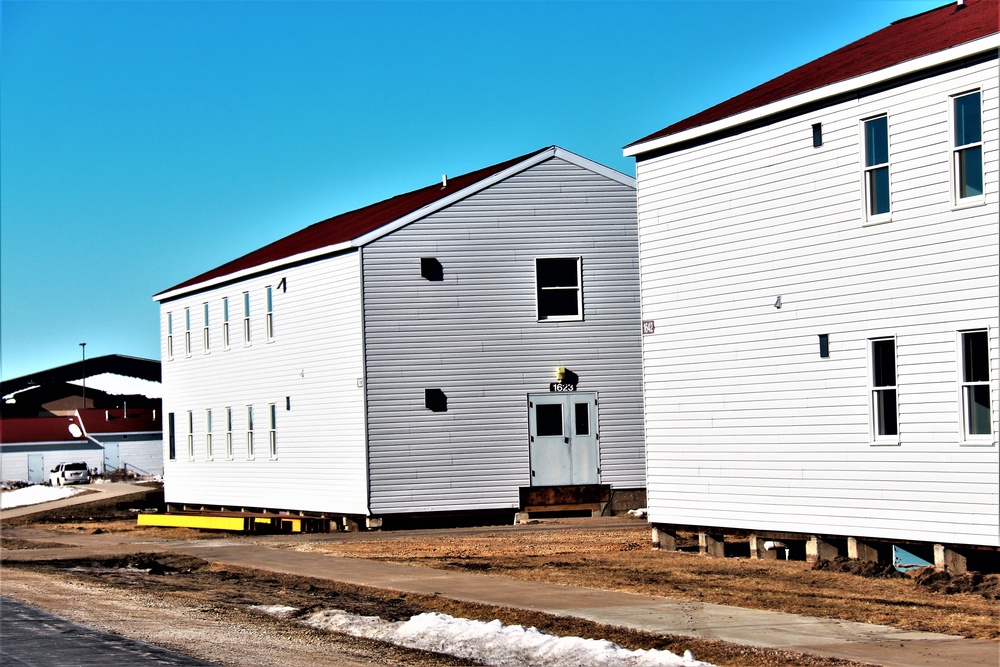 Contractors moving four World War II-era barracks buildings at Fort McCoy