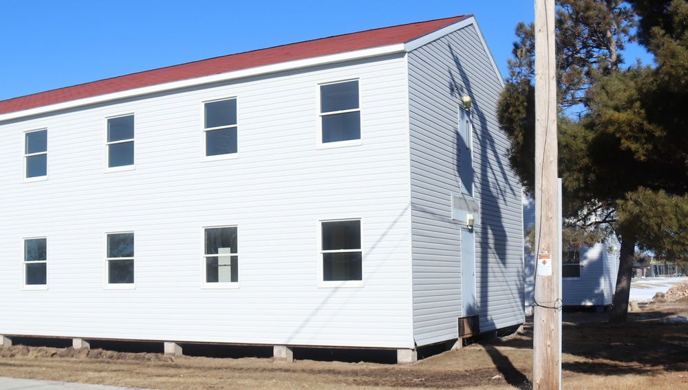 Contractors moving four World War II-era barracks buildings at Fort McCoy