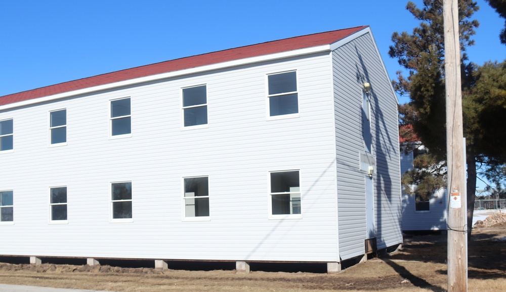 Contractors moving four World War II-era barracks buildings at Fort McCoy