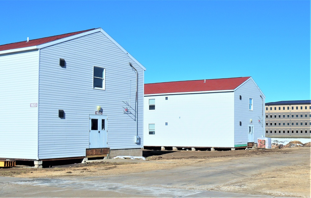 Contractors moving four World War II-era barracks buildings at Fort McCoy