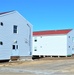 Contractors moving four World War II-era barracks buildings at Fort McCoy