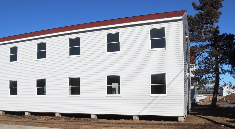 Contractors moving four World War II-era barracks buildings at Fort McCoy