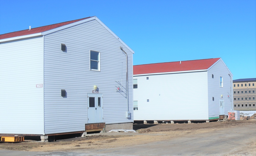 Contractors moving four World War II-era barracks buildings at Fort McCoy