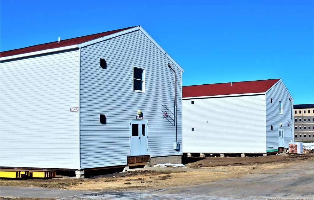 Contractors moving four World War II-era barracks buildings at Fort McCoy