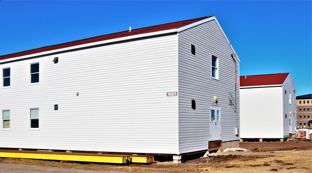 Contractors moving four World War II-era barracks buildings at Fort McCoy