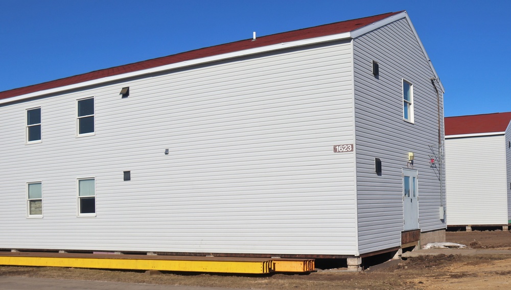 Contractors moving four World War II-era barracks buildings at Fort McCoy