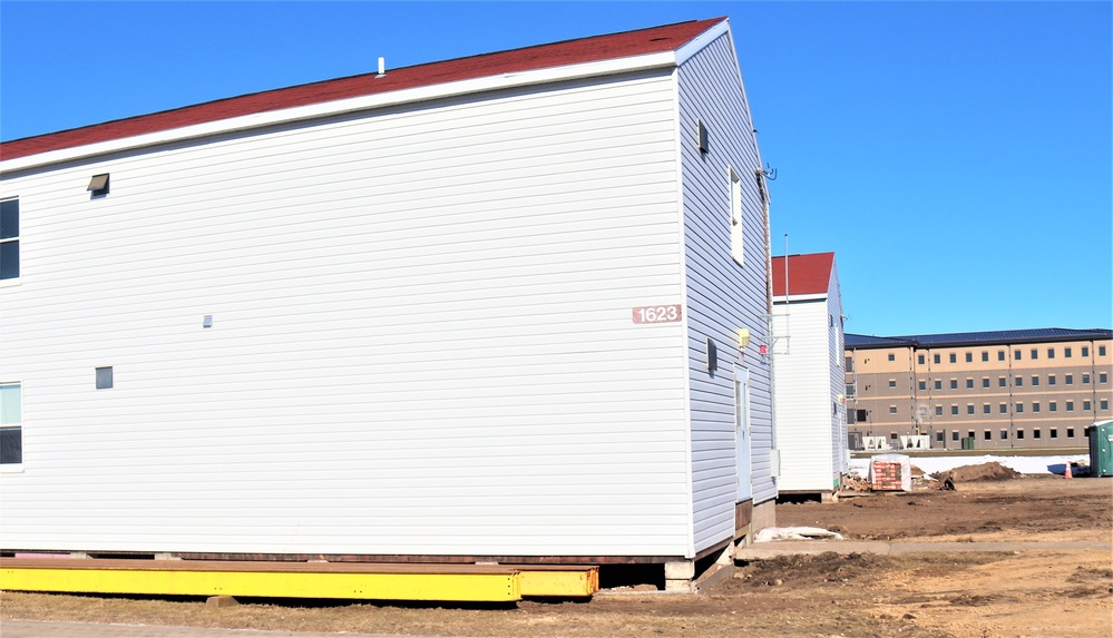 Contractors moving four World War II-era barracks buildings at Fort McCoy