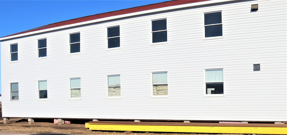 Contractors moving four World War II-era barracks buildings at Fort McCoy