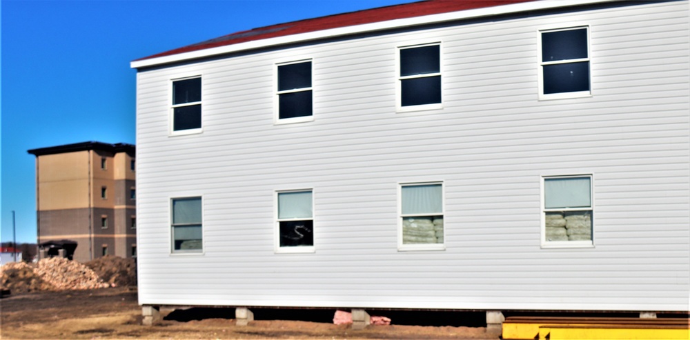 Contractors moving four World War II-era barracks buildings at Fort McCoy