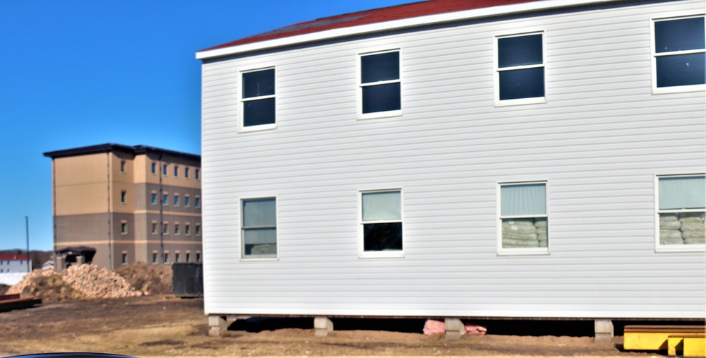 Contractors moving four World War II-era barracks buildings at Fort McCoy