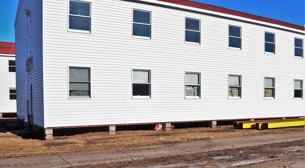 Contractors moving four World War II-era barracks buildings at Fort McCoy