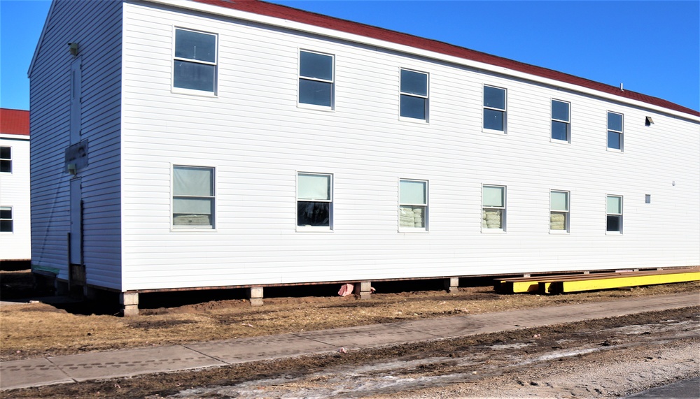 Contractors moving four World War II-era barracks buildings at Fort McCoy