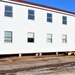 Contractors moving four World War II-era barracks buildings at Fort McCoy