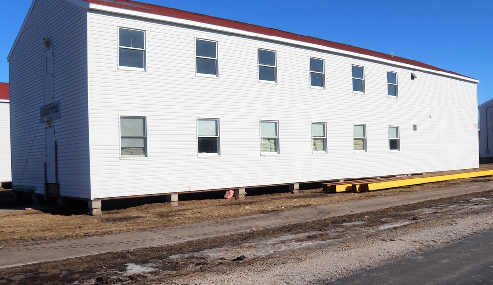 Contractors moving four World War II-era barracks buildings at Fort McCoy