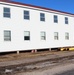 Contractors moving four World War II-era barracks buildings at Fort McCoy