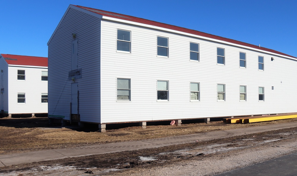 Contractors moving four World War II-era barracks buildings at Fort McCoy