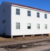 Contractors moving four World War II-era barracks buildings at Fort McCoy