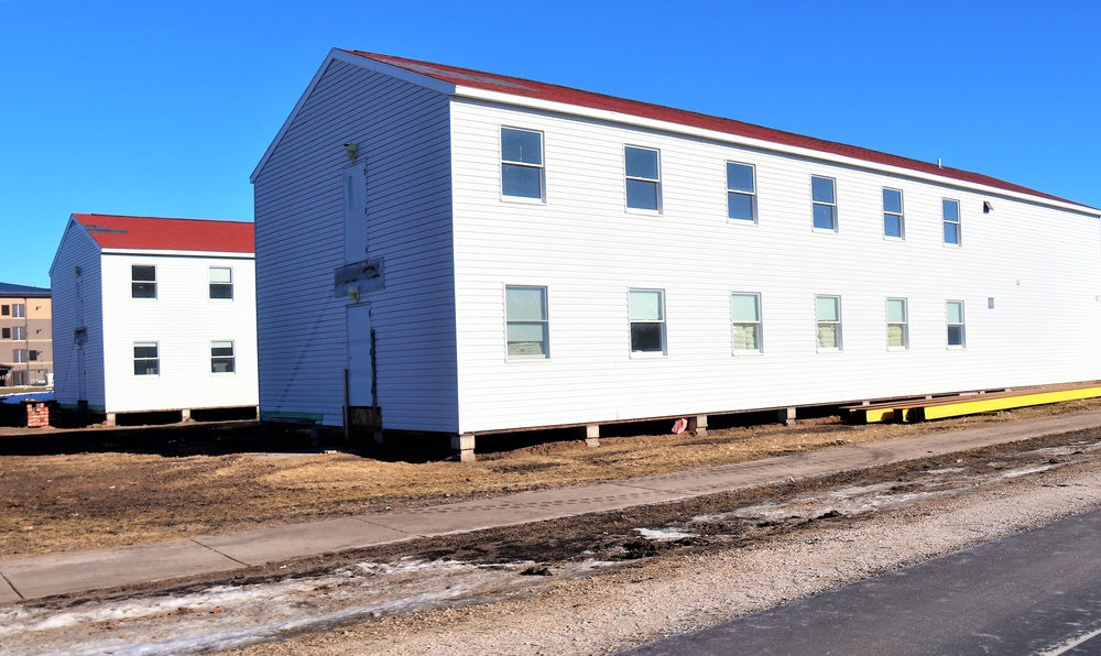 Contractors moving four World War II-era barracks buildings at Fort McCoy