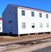 Contractors moving four World War II-era barracks buildings at Fort McCoy