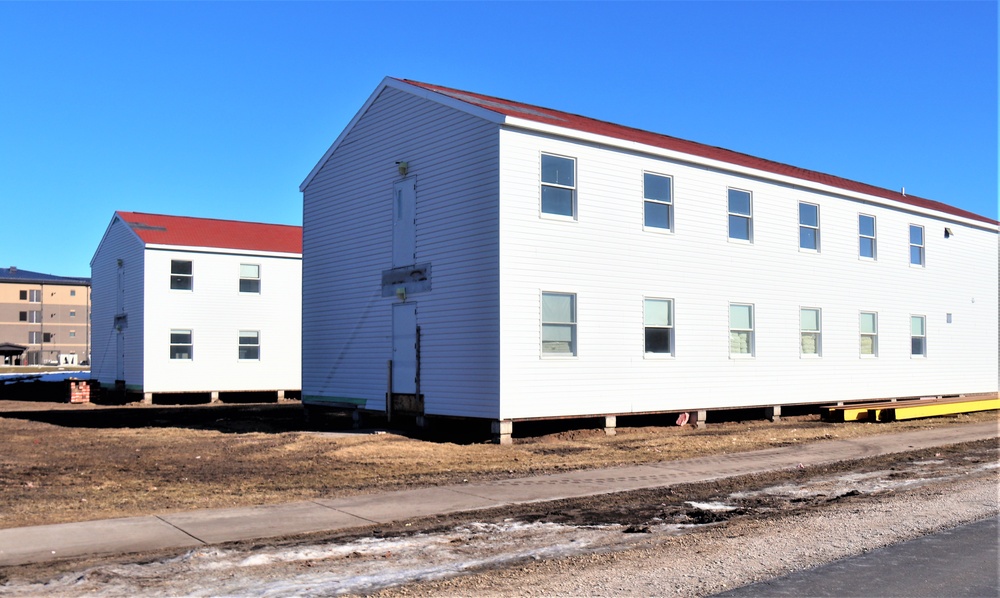 Contractors moving four World War II-era barracks buildings at Fort McCoy