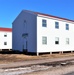 Contractors moving four World War II-era barracks buildings at Fort McCoy