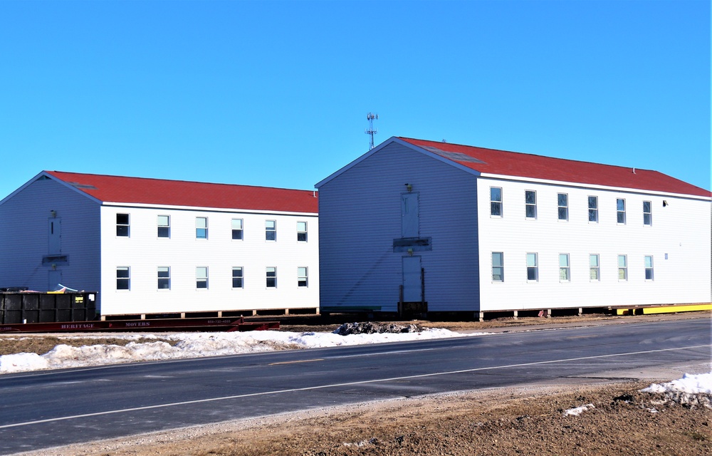 Contractors moving four World War II-era barracks buildings at Fort McCoy